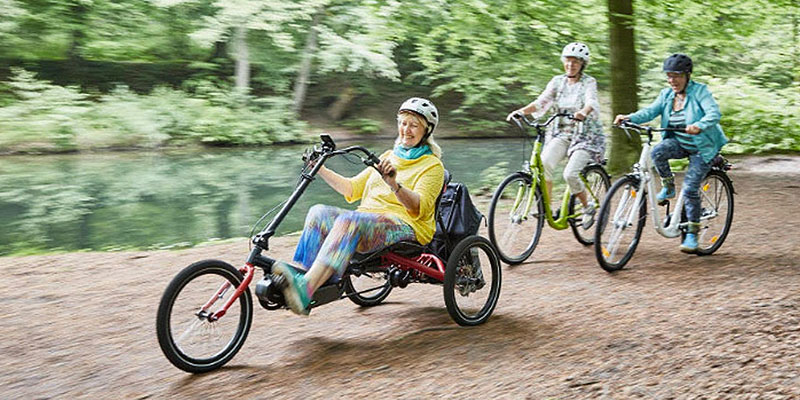 Women cycling with a woman riding a Hase TRIGO UP recumbent trike in front