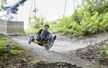 Gunther riding a Kettwiesel Kross off-road recumbent trike down a hill