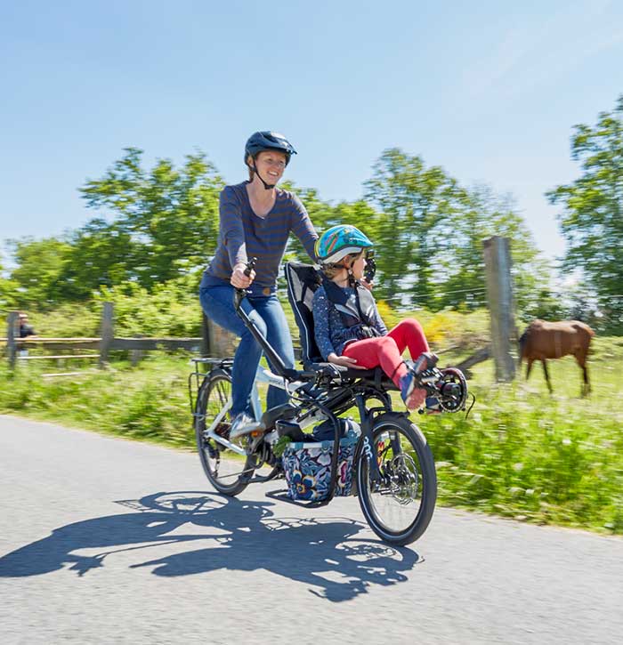 Woman and girl riding a Hase Pino STEPS tandem bike