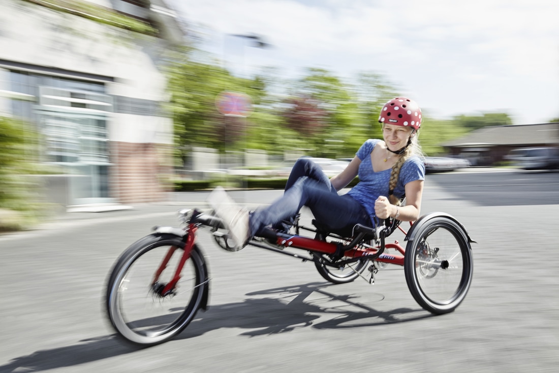 Woman riding a Hase Kettwiesel recumbent trike