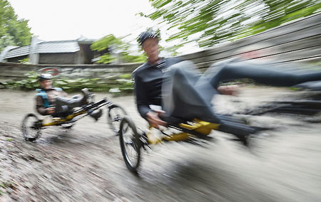 Two men riding Kettwiesel Kross recumbent trikes off-road