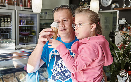 Father and daughter enjoying an ice cream cone